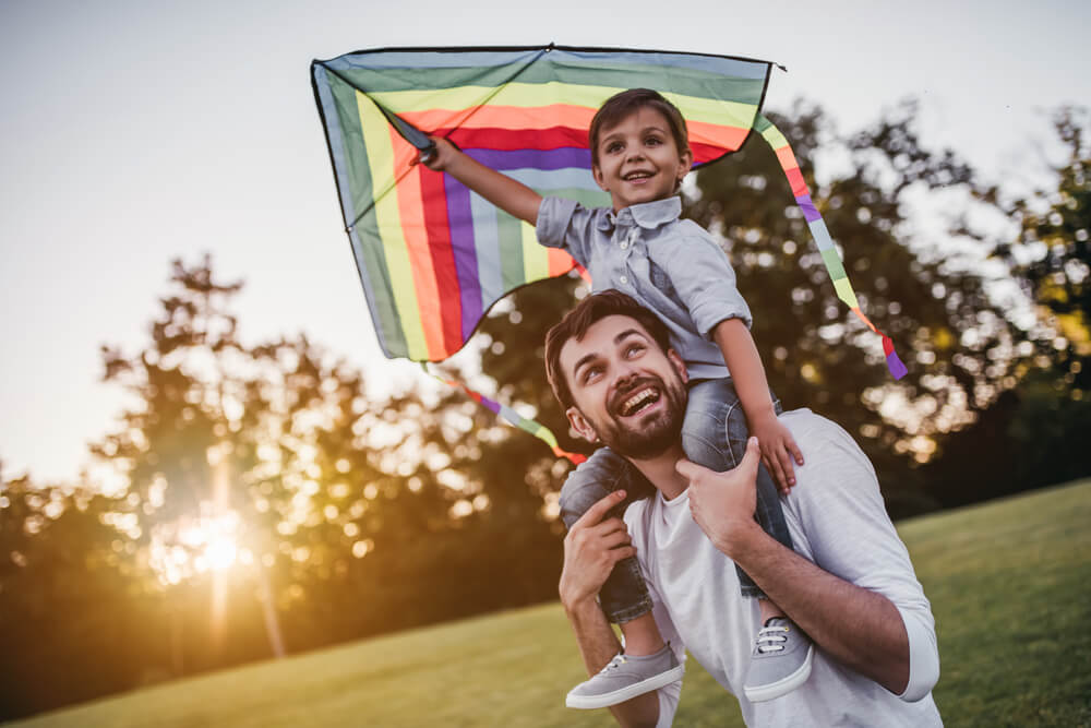 father and son flying a kite